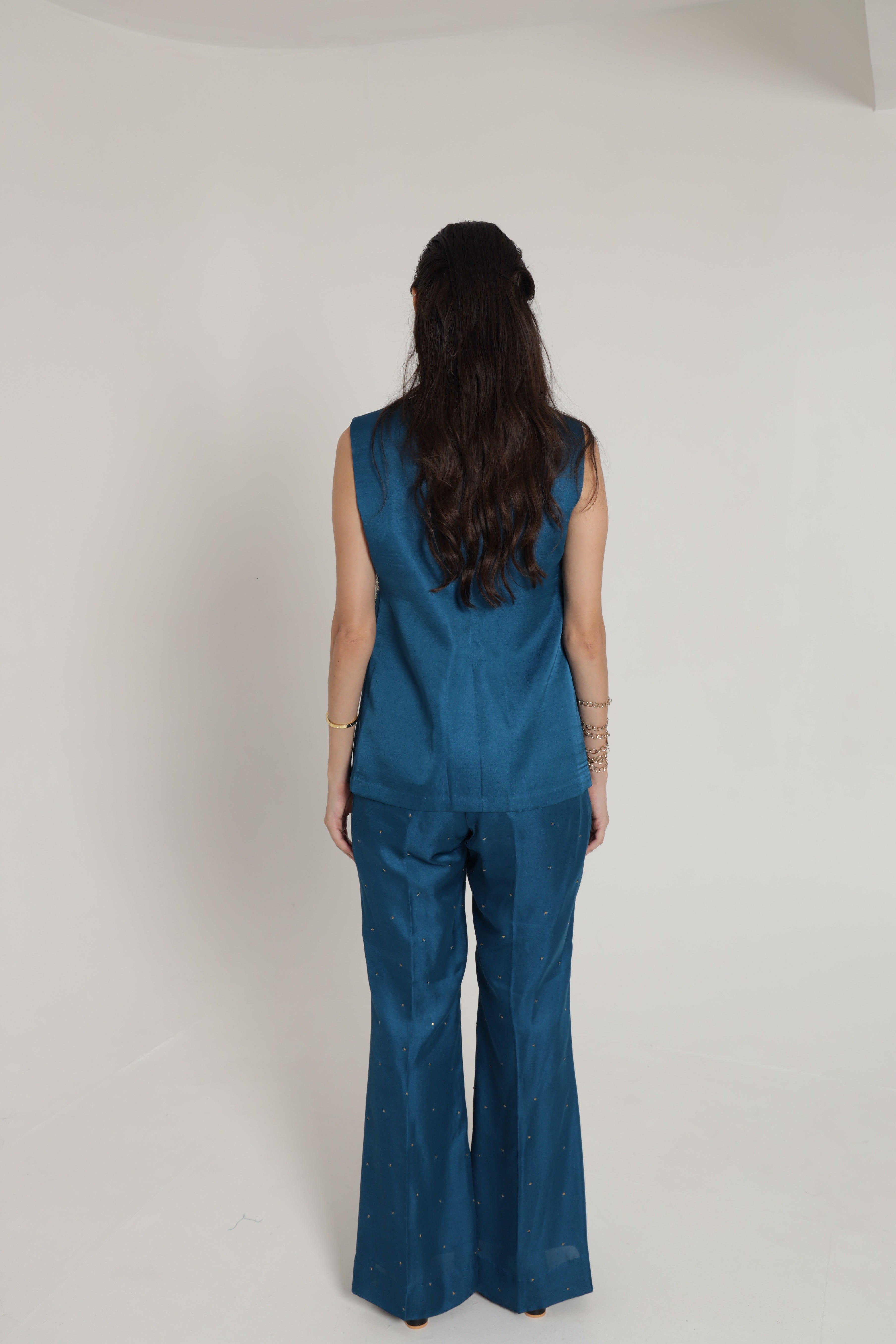 Teal blue sleeveless jacket with bell bottom pant