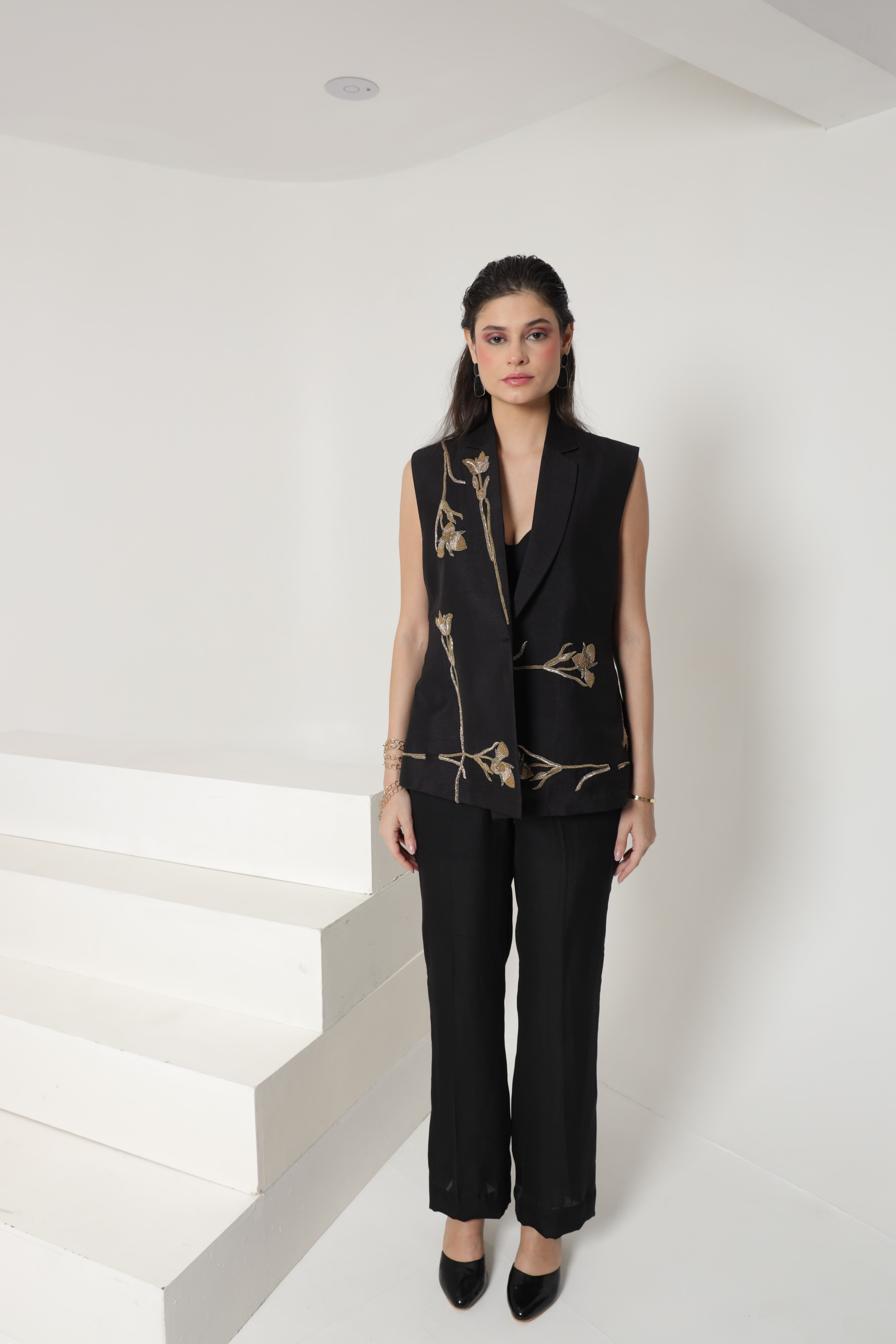 Black sleeveless jacket set with straight leg pants and bustier