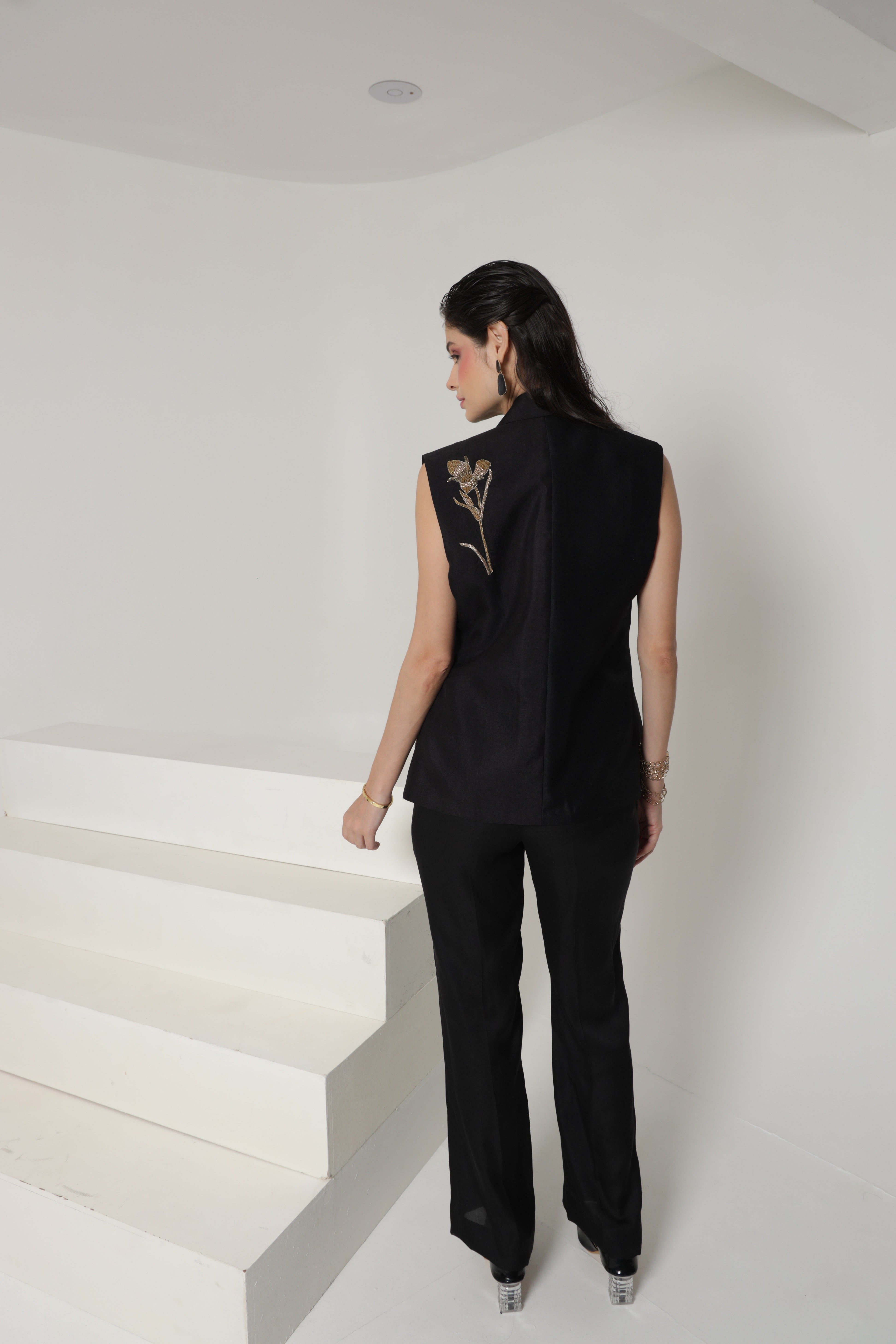 Black sleeveless jacket set with straight leg pants and bustier