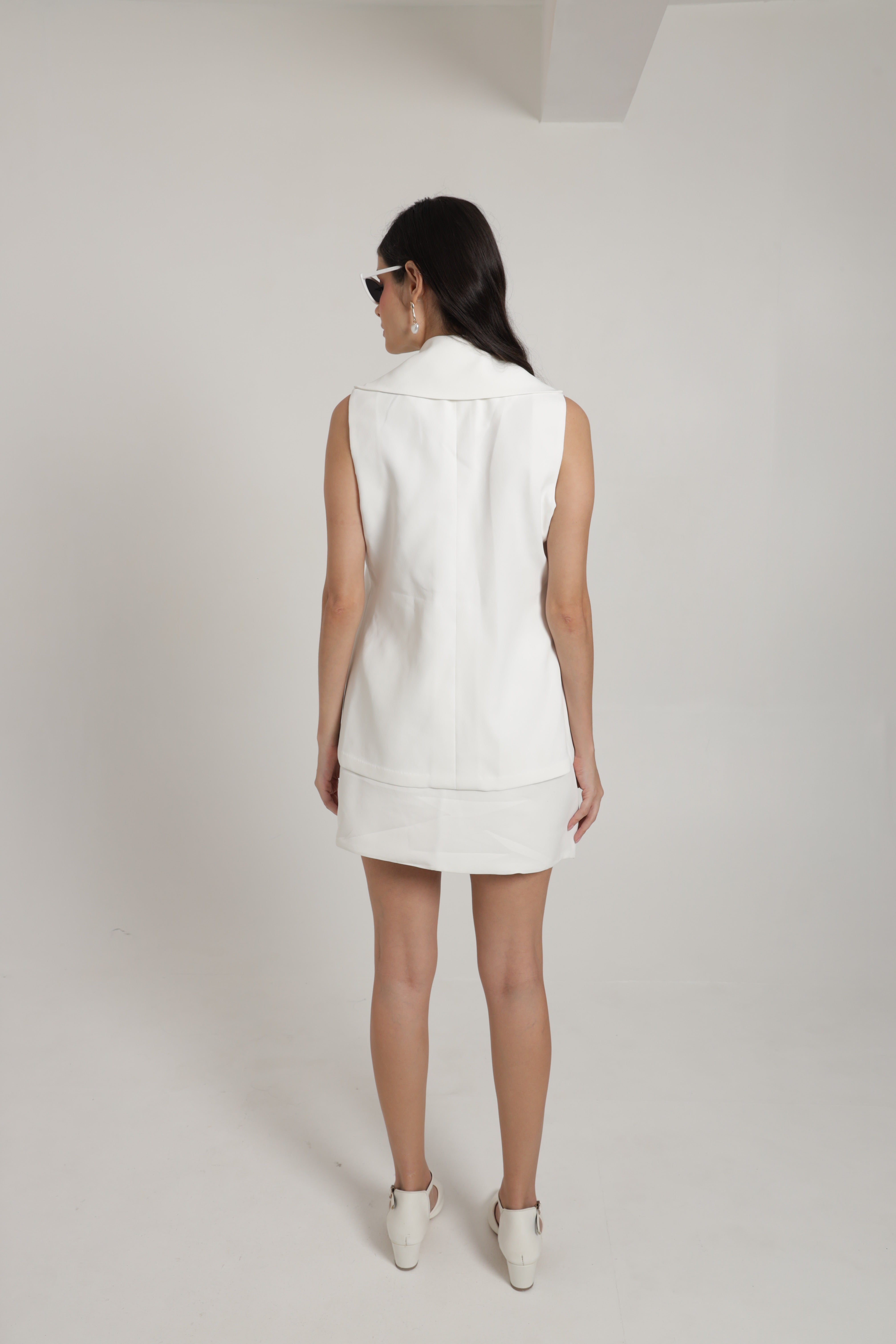 White sleeveless jacket with mini skirt