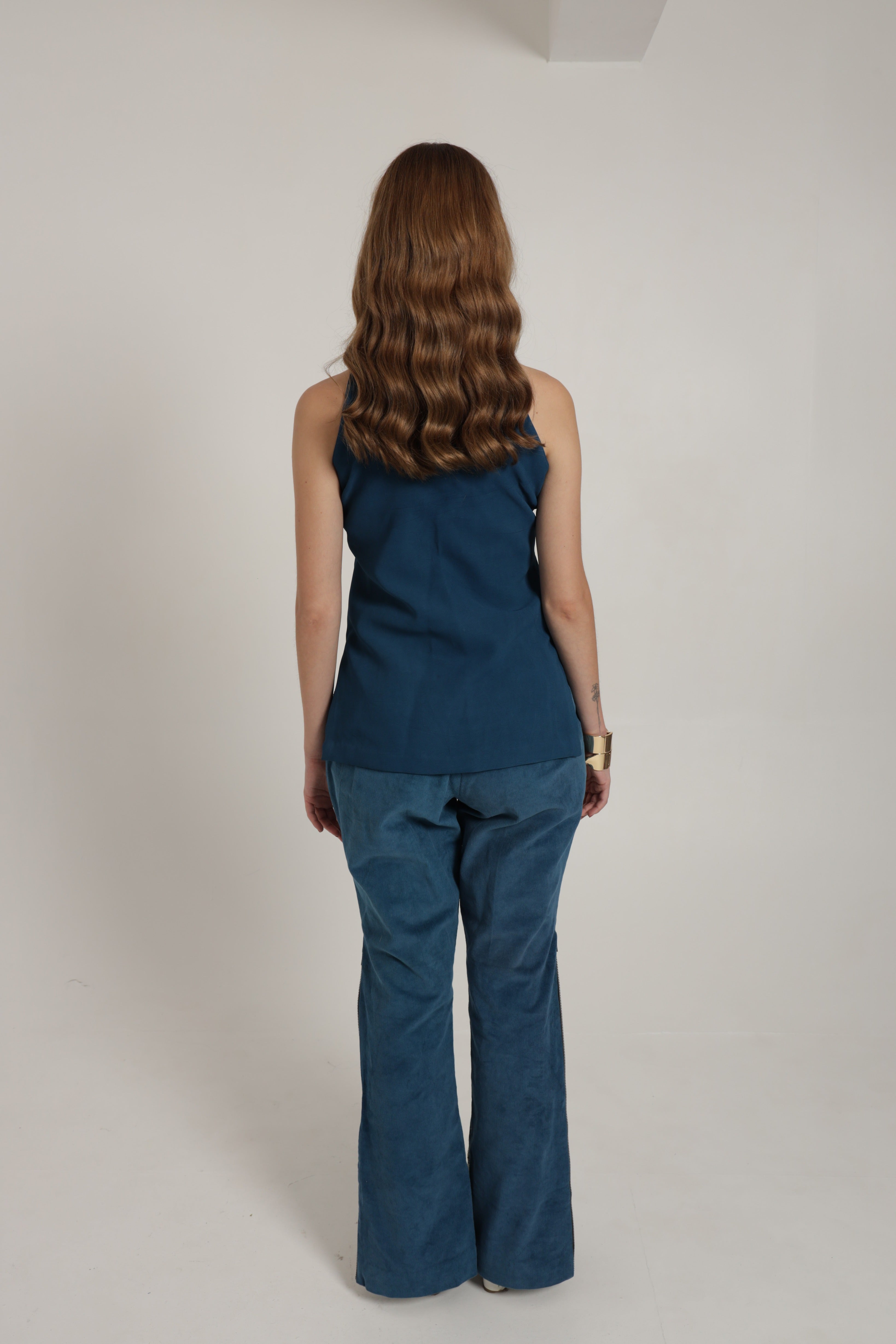 Dark blue halter top with straight corduroy pants