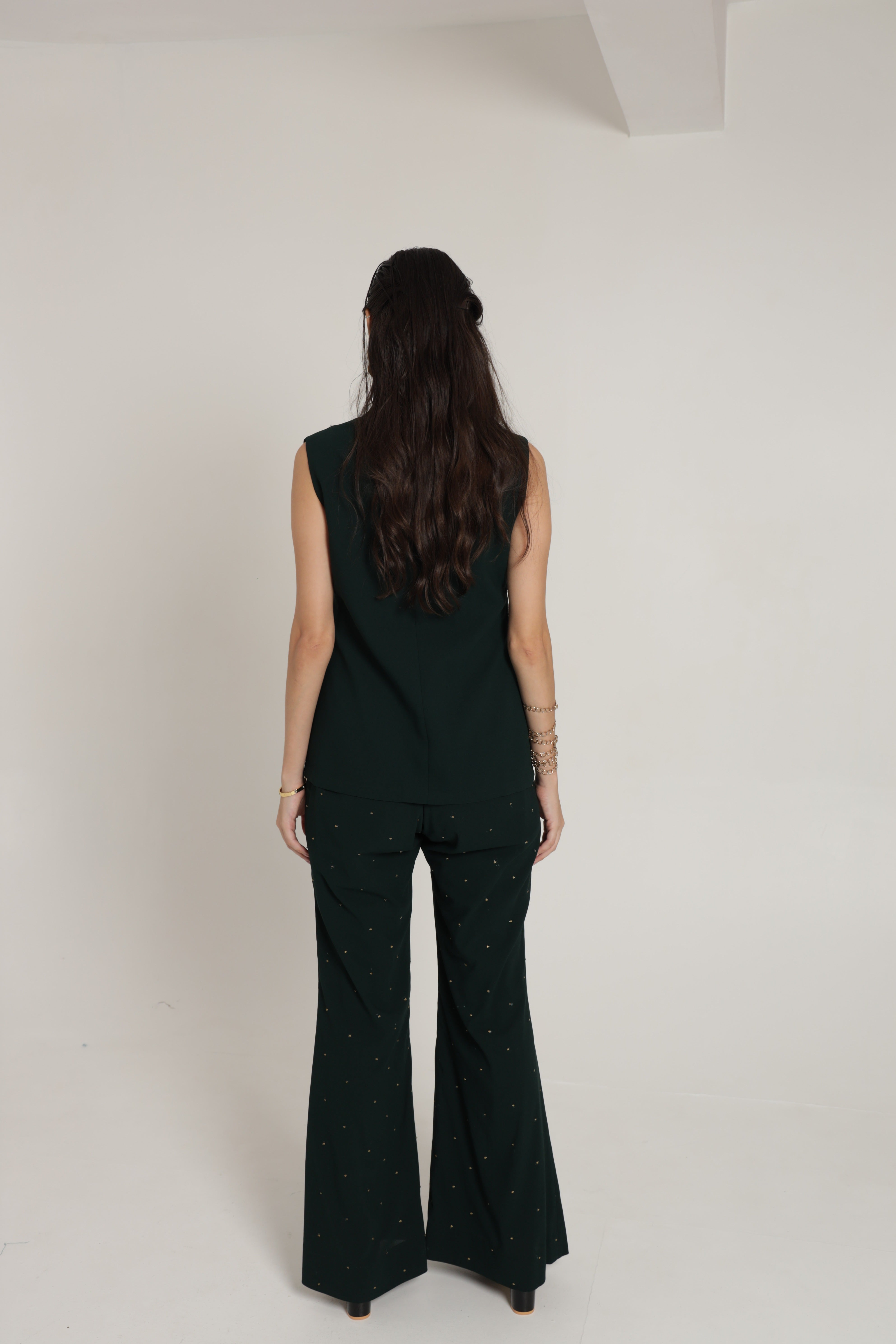 Dark green sleeveless jacket with bell bottom pant and bustier