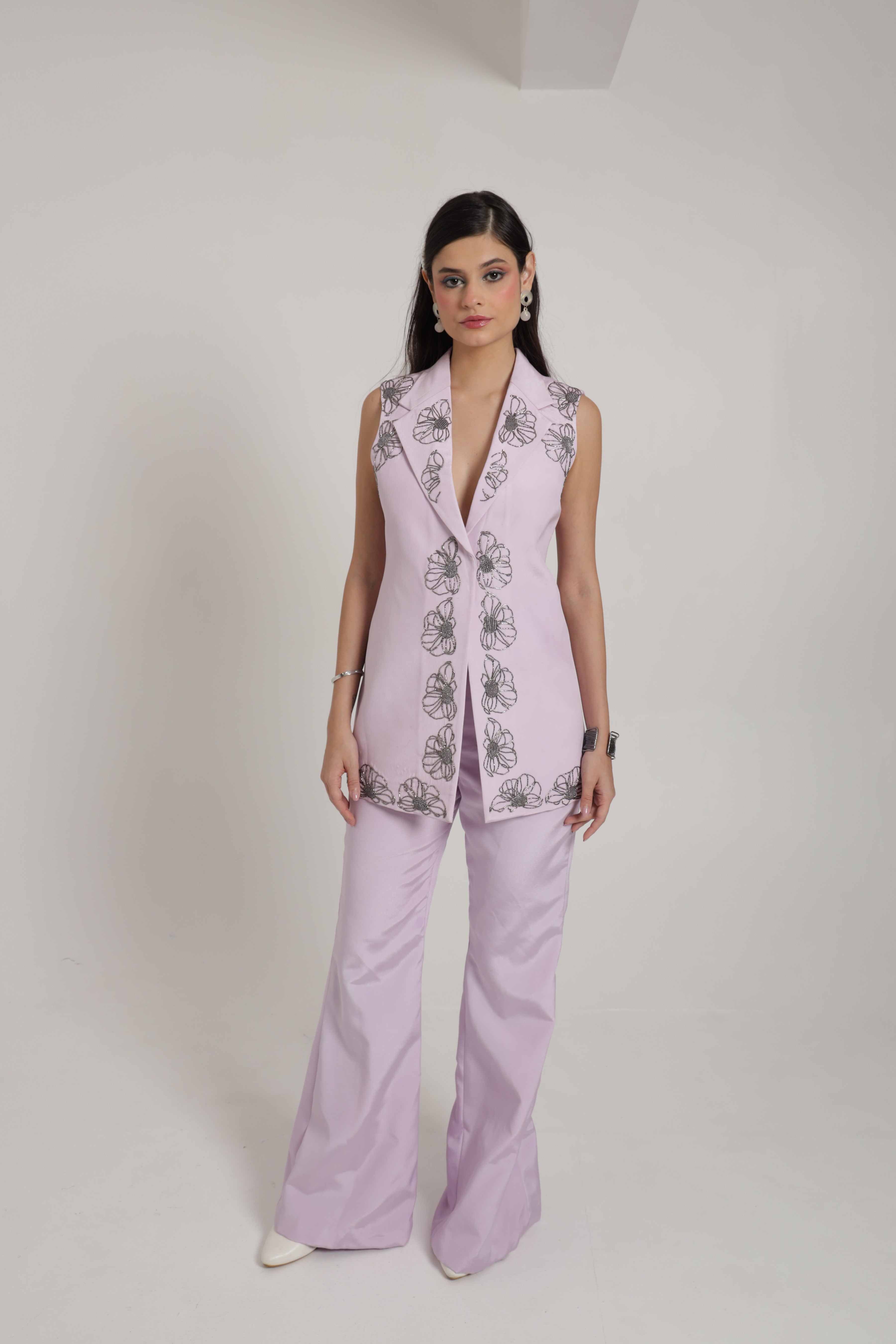 Lavender sleeveless jacket with bell bottom pants and bustier
