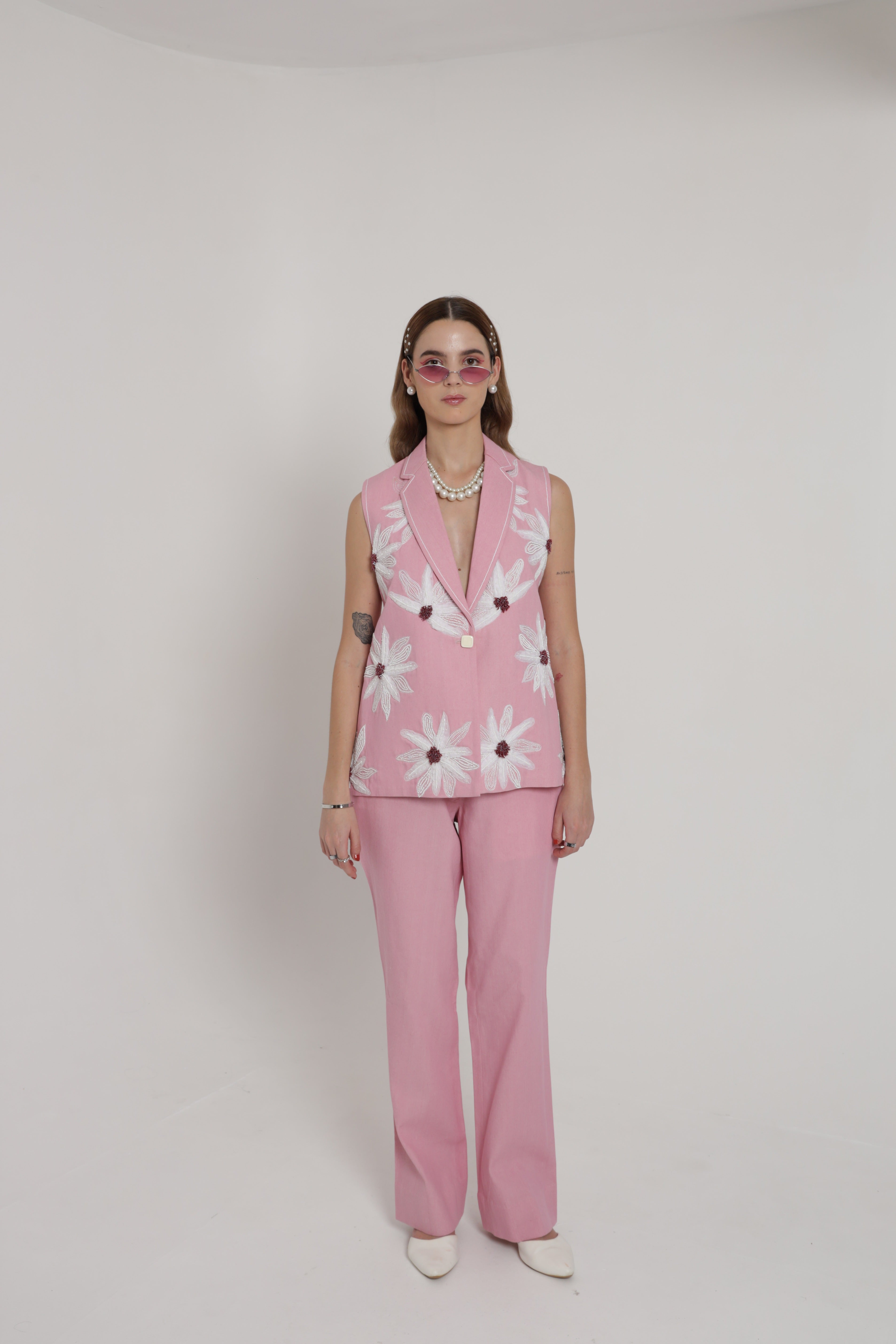 Pink sleeveless jacket with straight pants and bustier