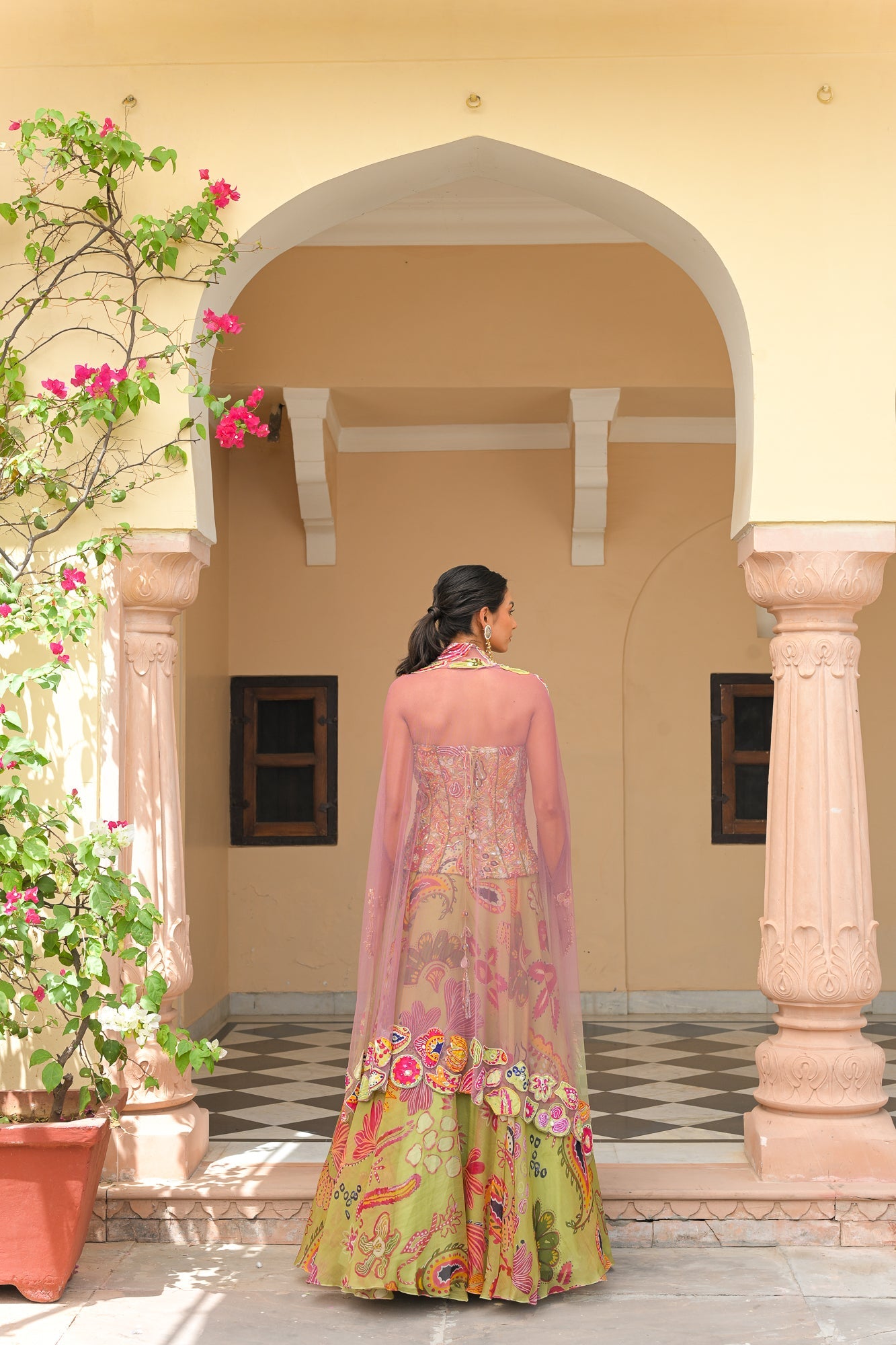 OLIVE BLOOM PRINTED LEHENGA AND EMBROIDERED. MIRROR CORSET AND APPLIQUÉ DUAL CAPE HIGHLIGHT