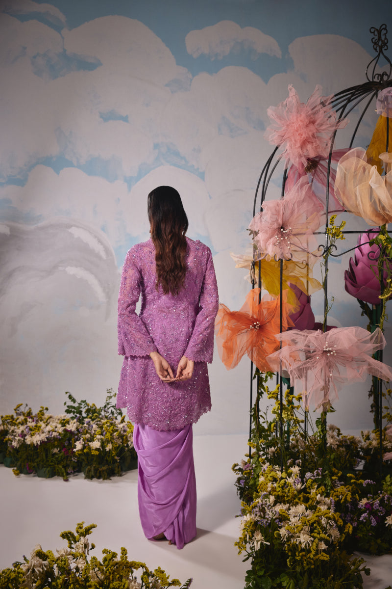 Lavender organza jacket with self dori embroidery paired with drape skirt and bustier