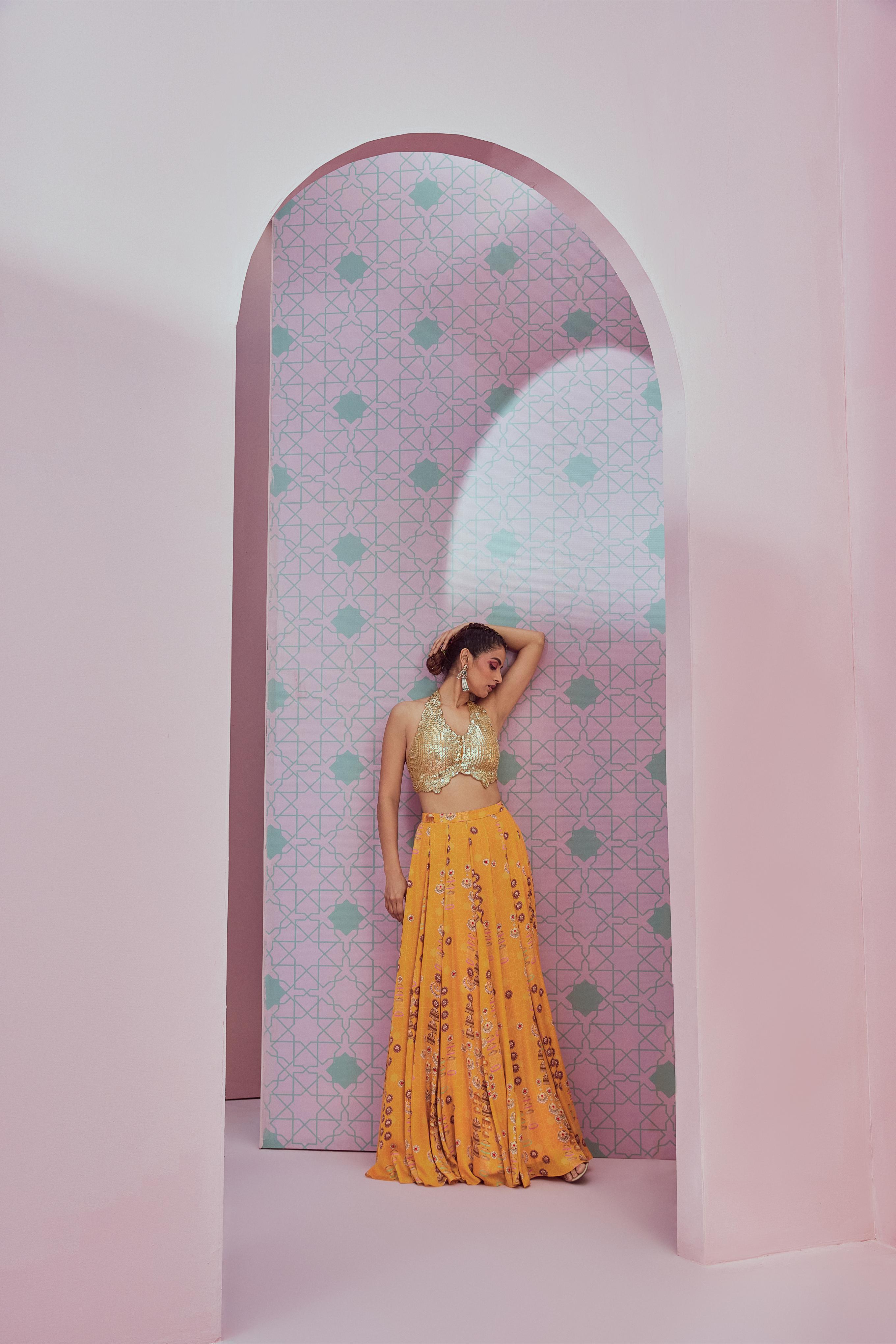 Sequence blouse paired with yellow flared lehenga