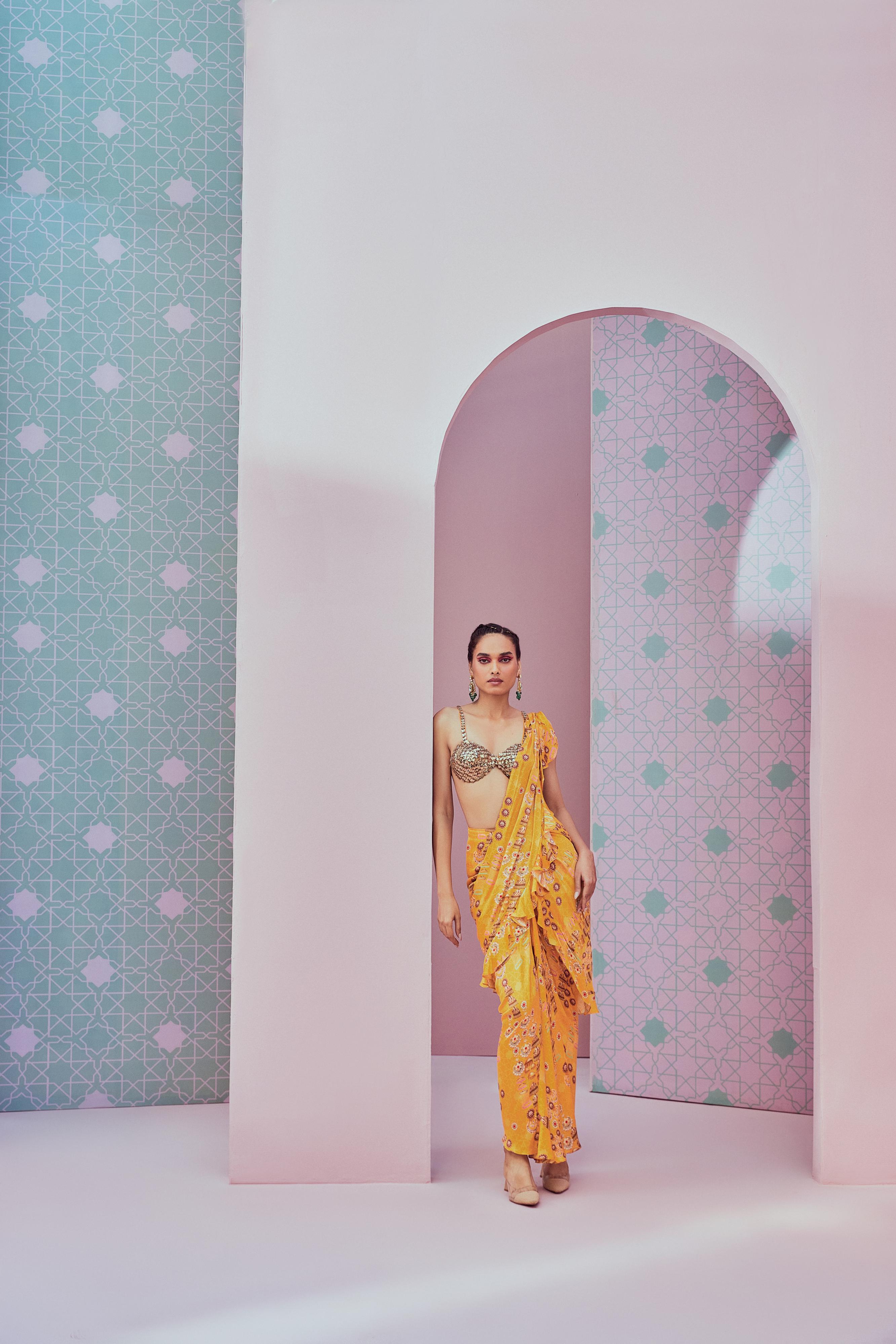 Crystal blouse paired with yellow pre stitched saree