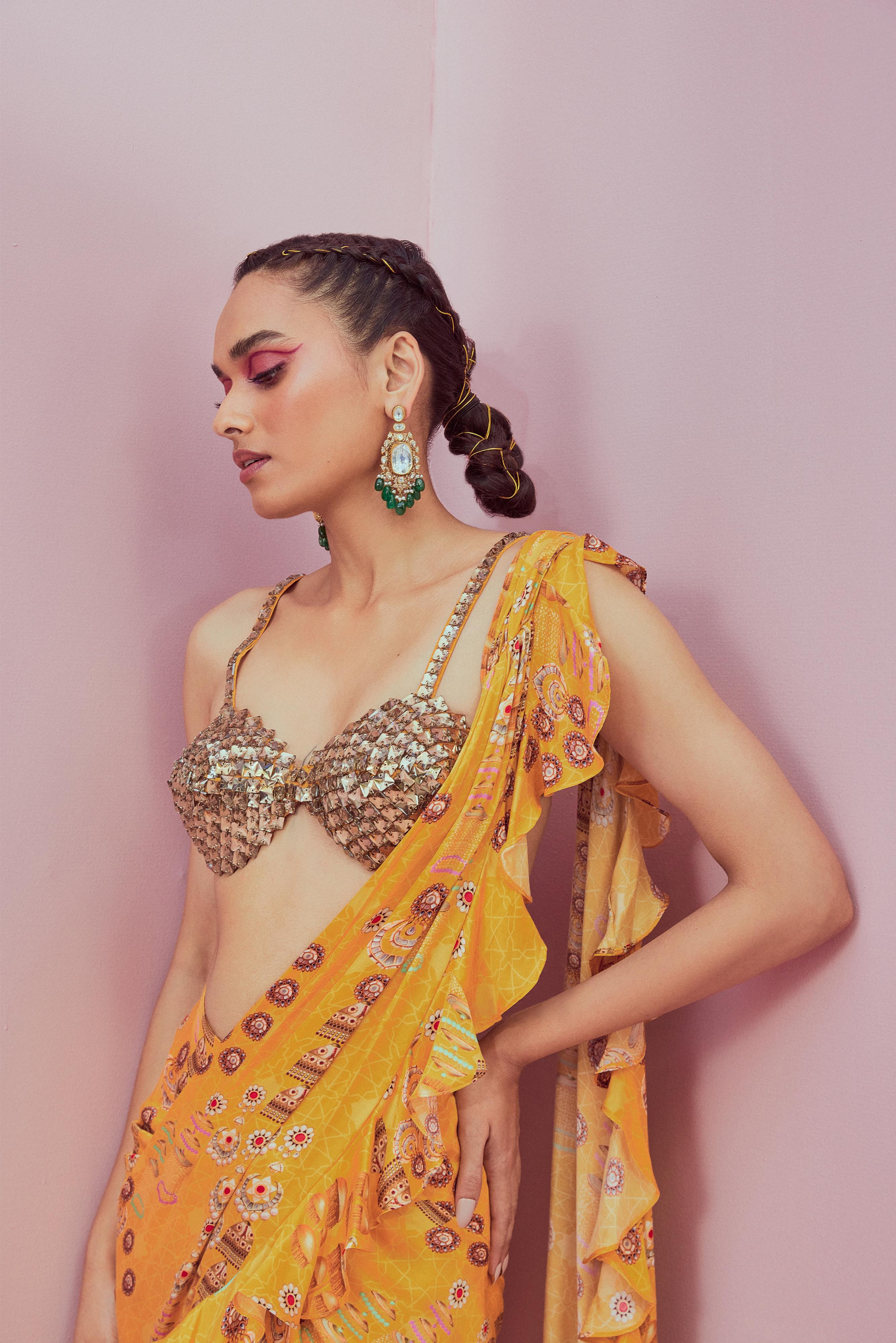 Crystal blouse paired with yellow pre stitched saree