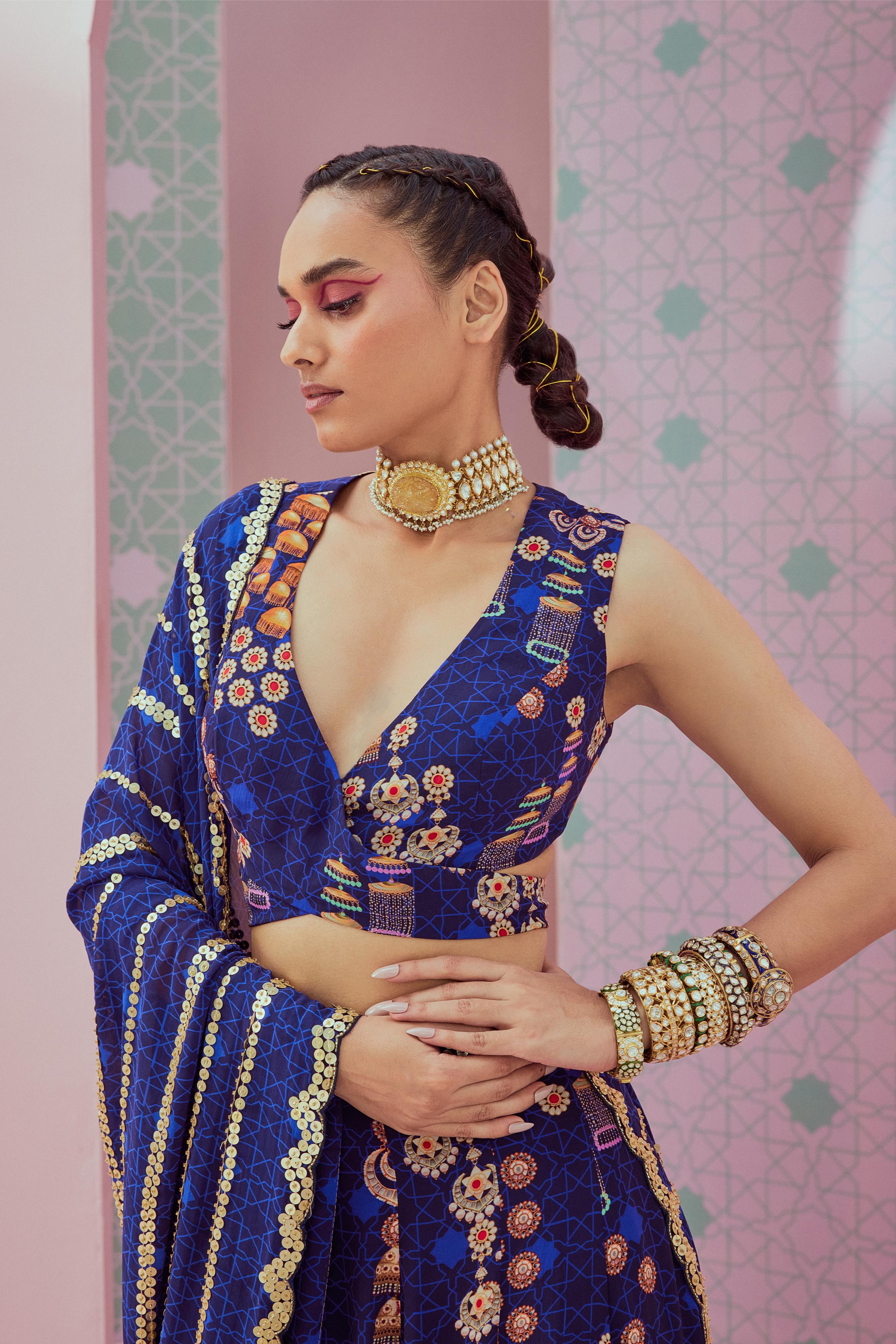 Blue criss cross blouse with slit lehenga paired up with heavy embellished dupatta