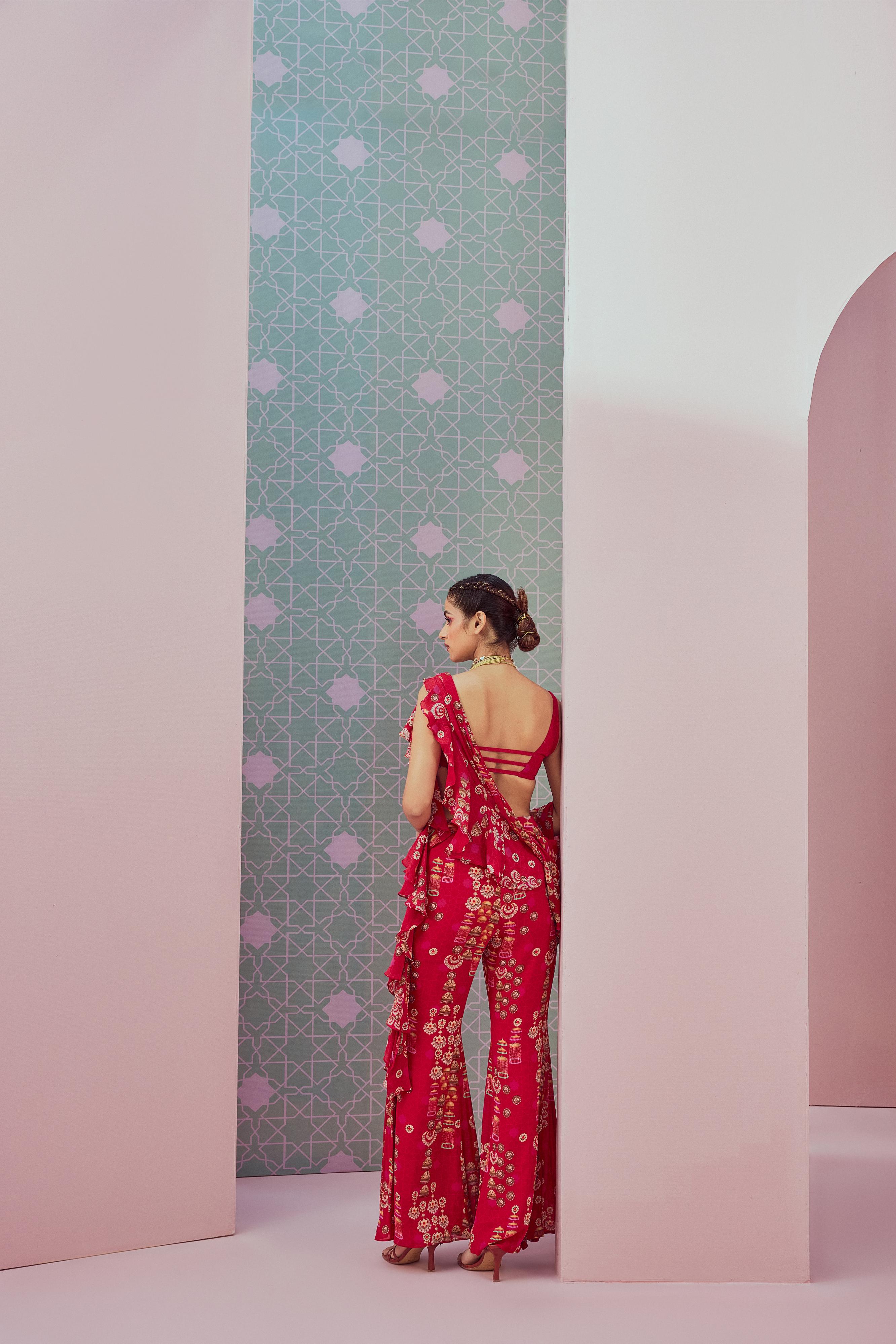 Sequence blouse paired with red ruffle saree drape