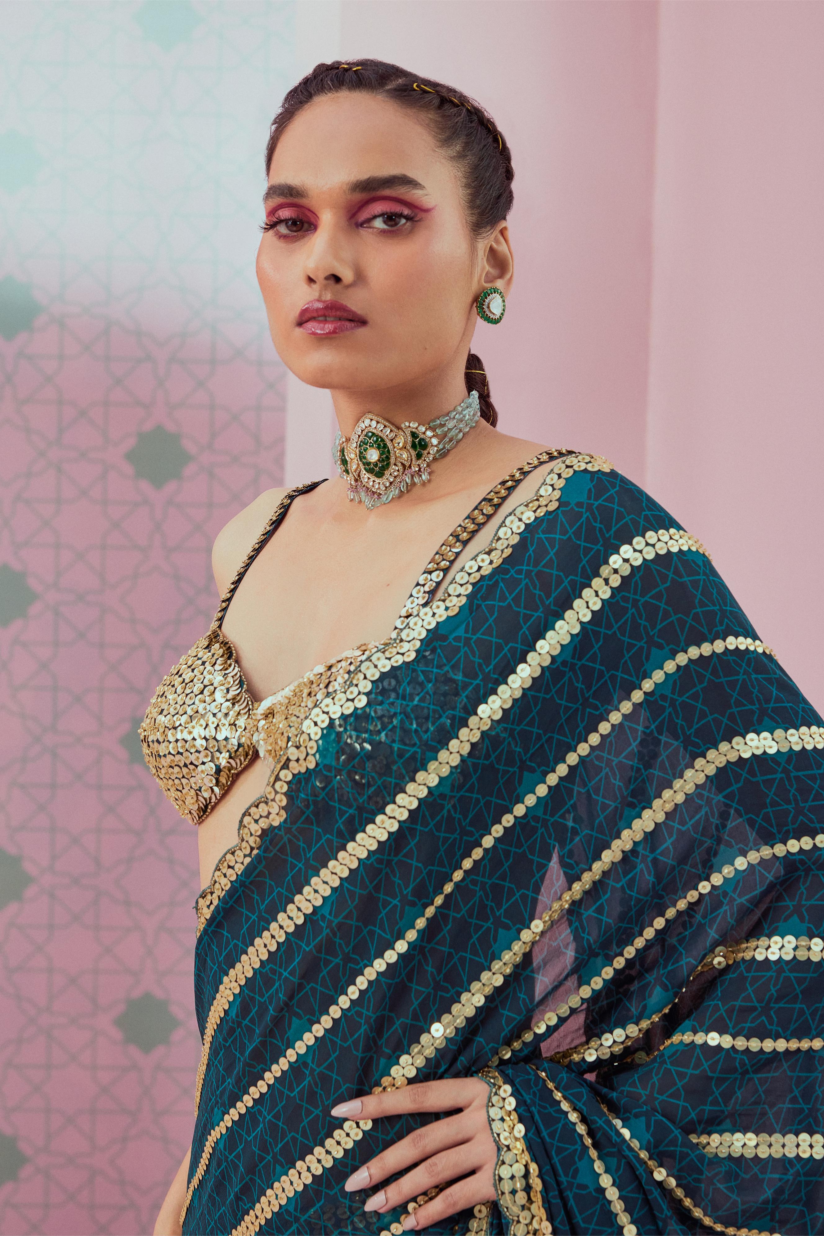 Embellished blouse paired with emrald green pre stitched saree