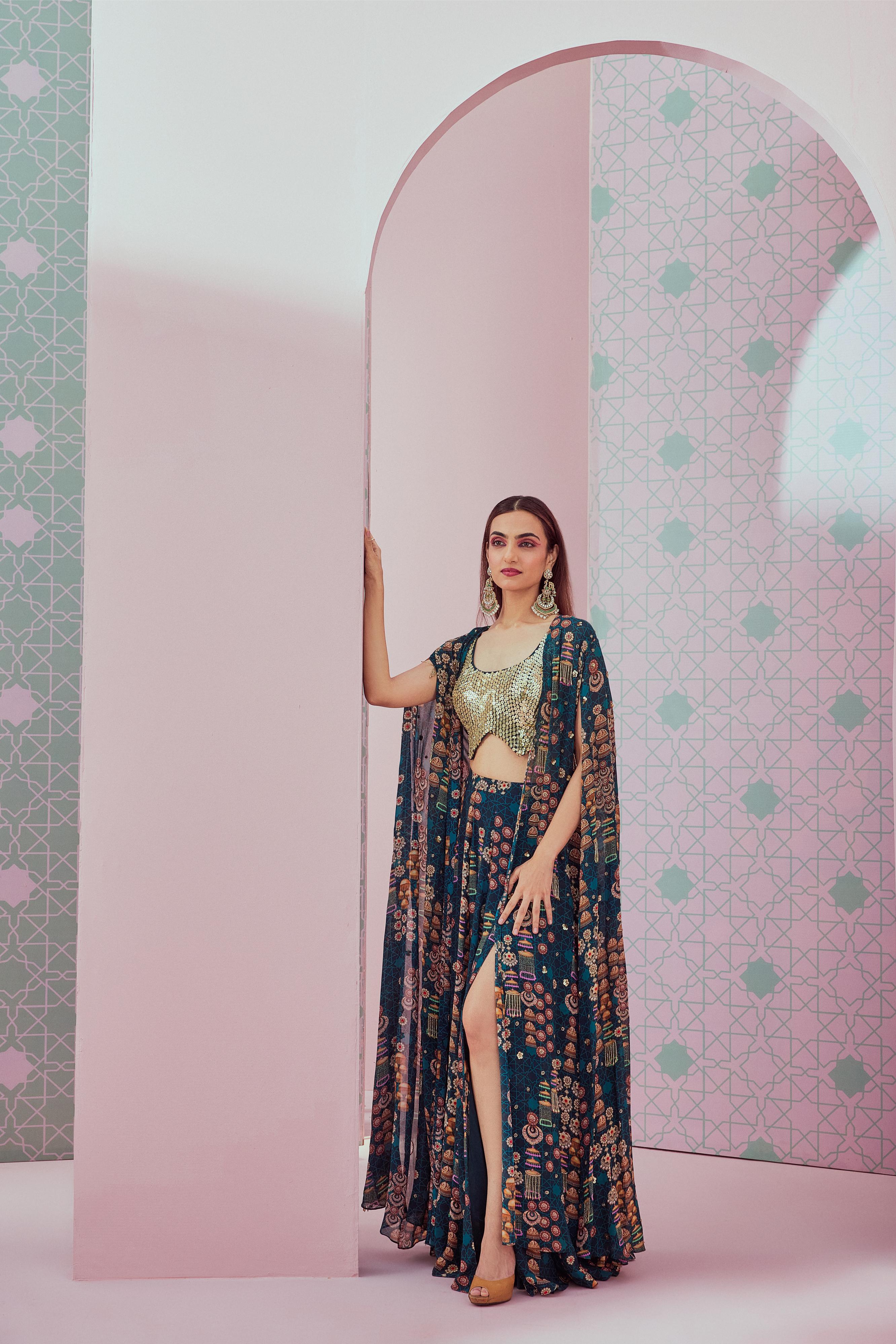 Embellished blouse paired with emerald green full length cape & slit skirt
