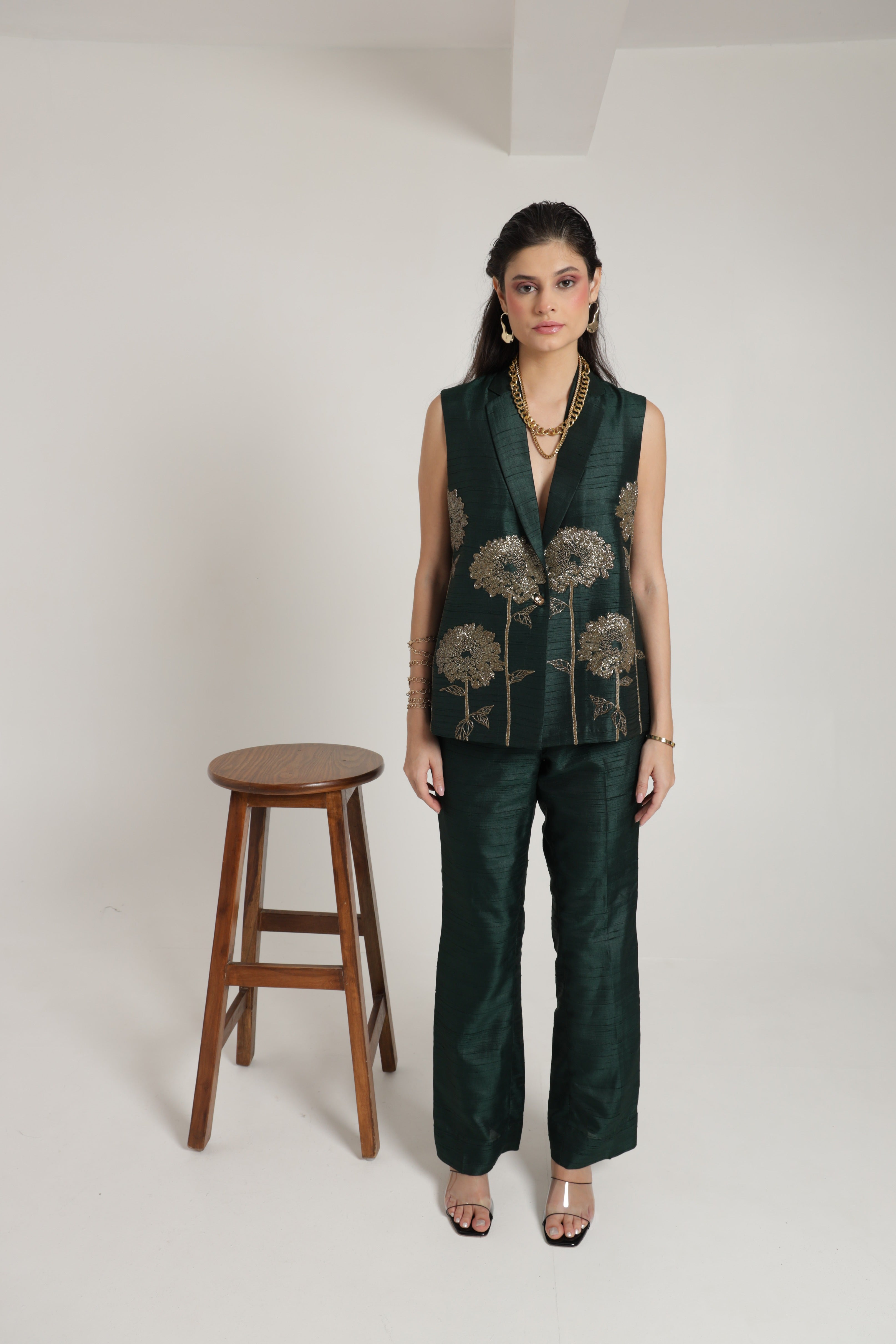 Dark green sleeveless jacket with straight pant and bustier