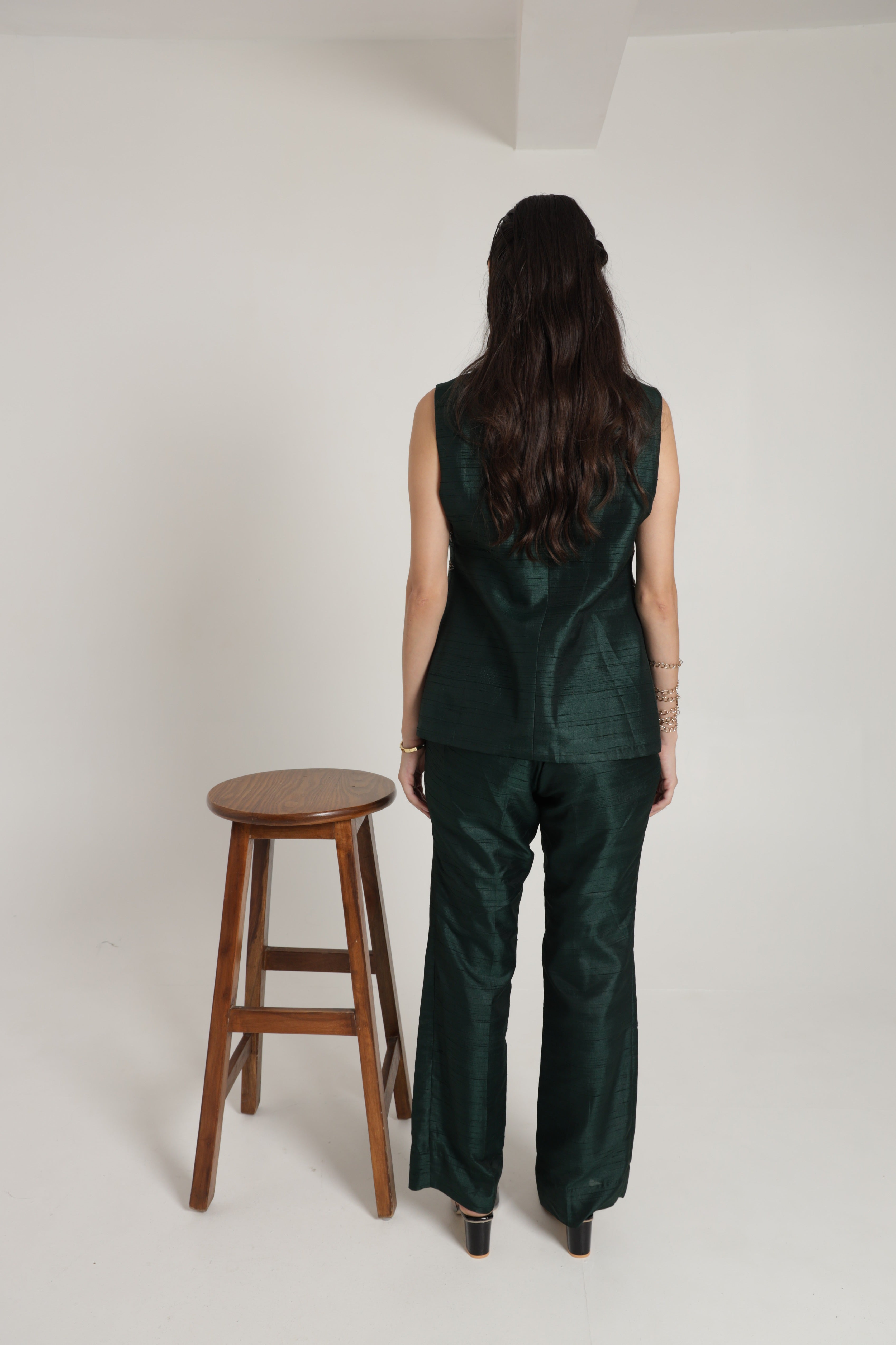 Dark green sleeveless jacket with straight pant and bustier