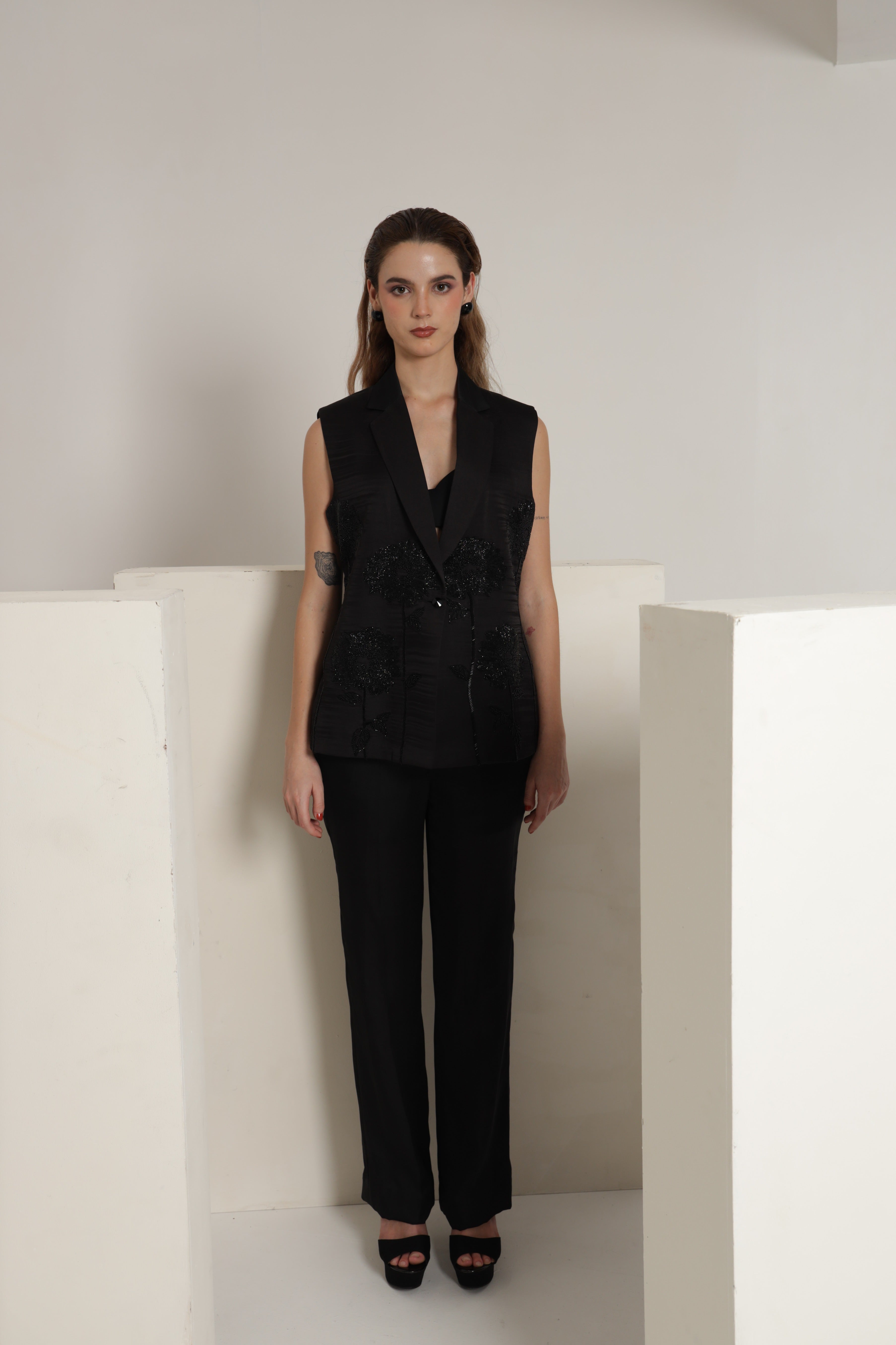 Black sleeveless jacket with straight pant and bustier