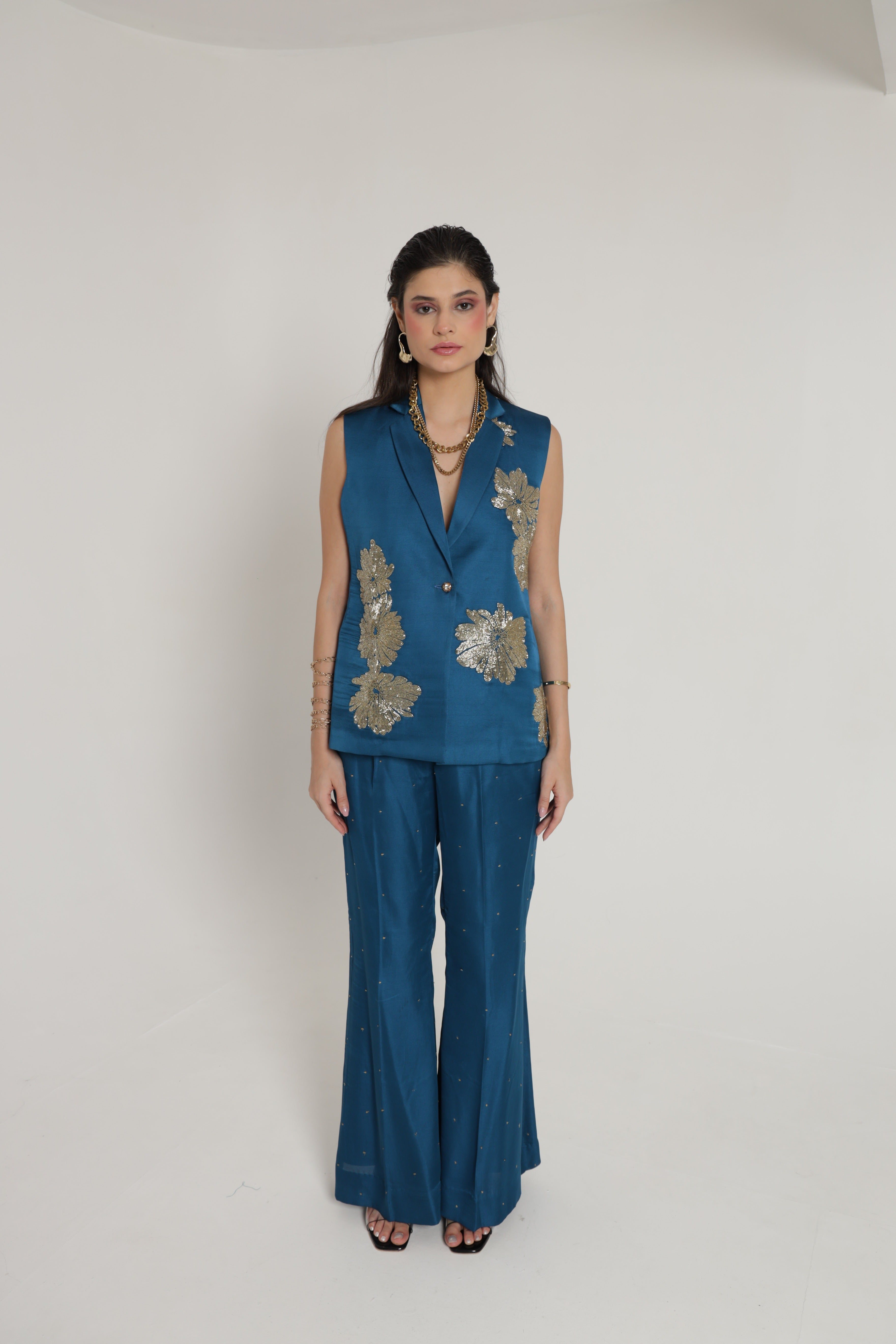 Teal blue sleeveless jacket with bell bottom pant