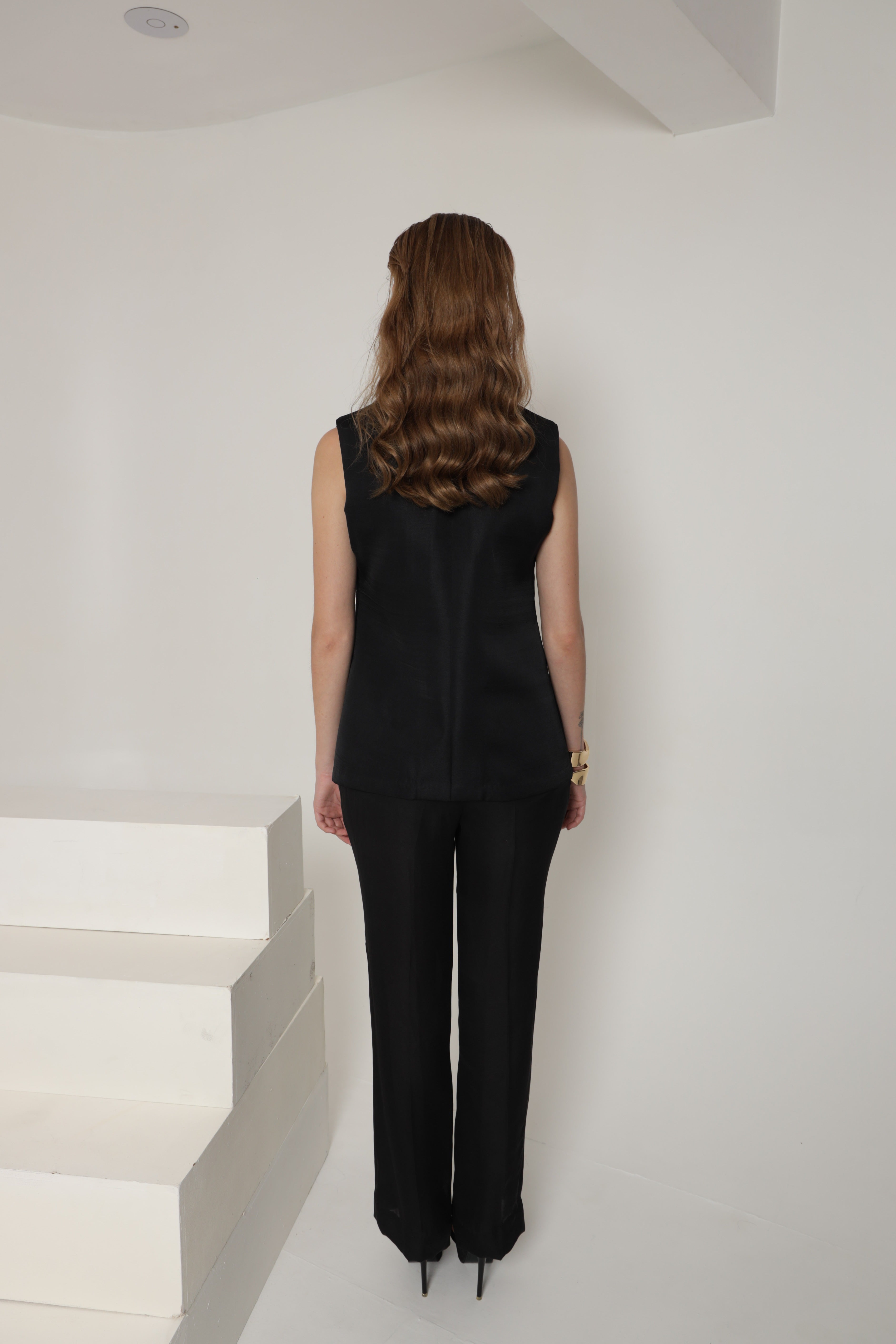 Black sleeveless jacket with pant and bustier