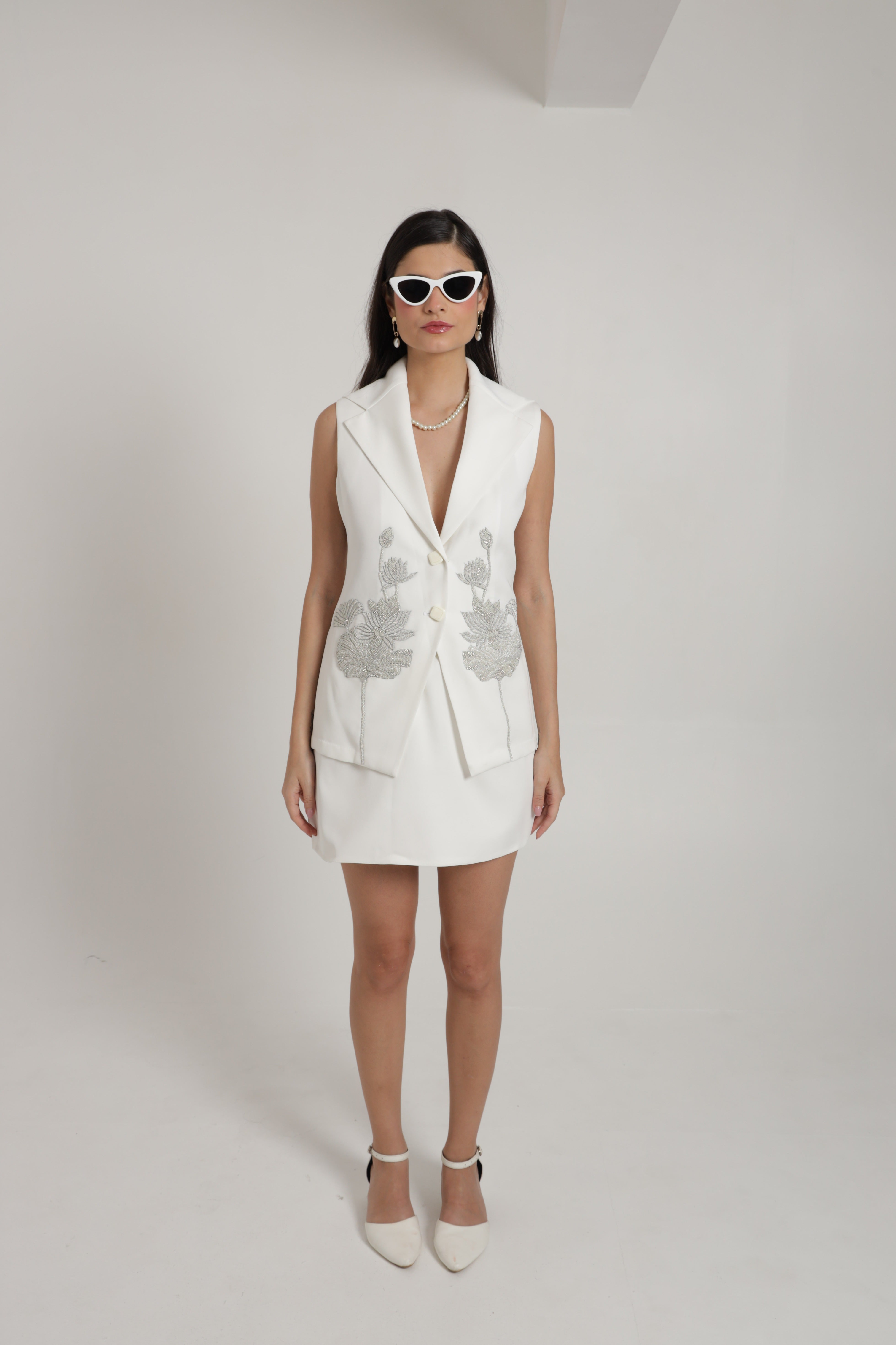 White sleeveless jacket with mini skirt
