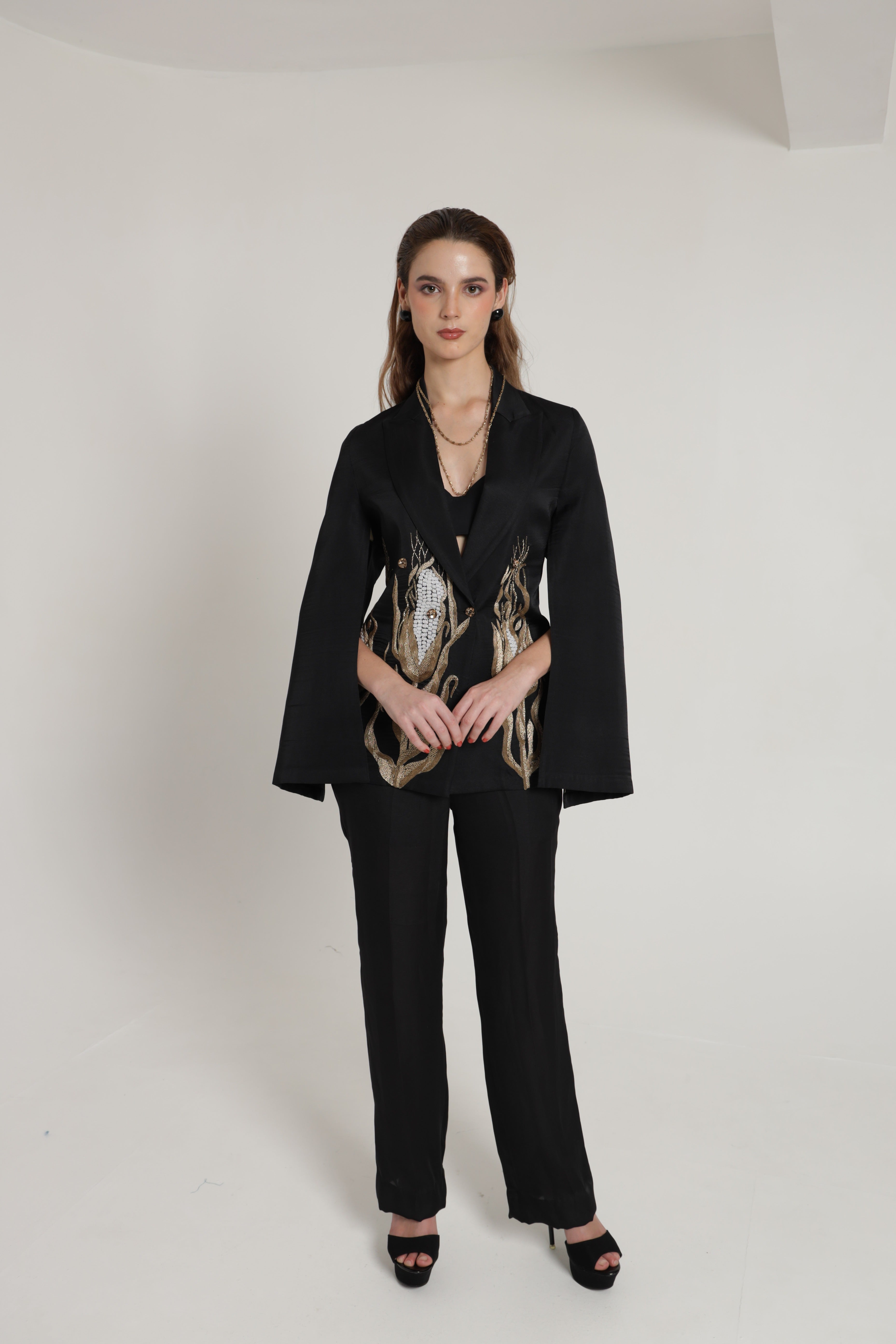 Black blazer with cape sleeves and straight pants