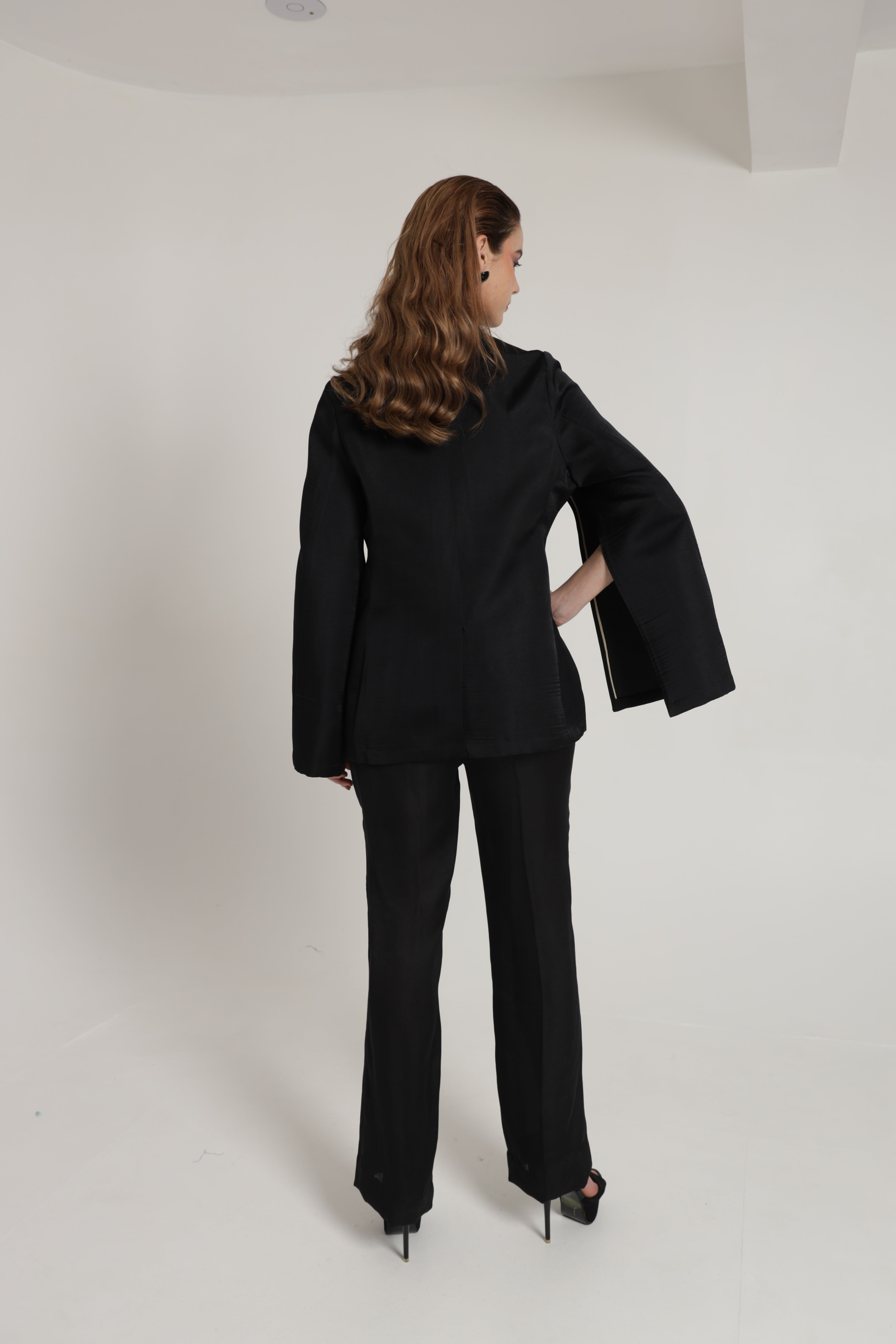 Black blazer with cape sleeves and straight pants