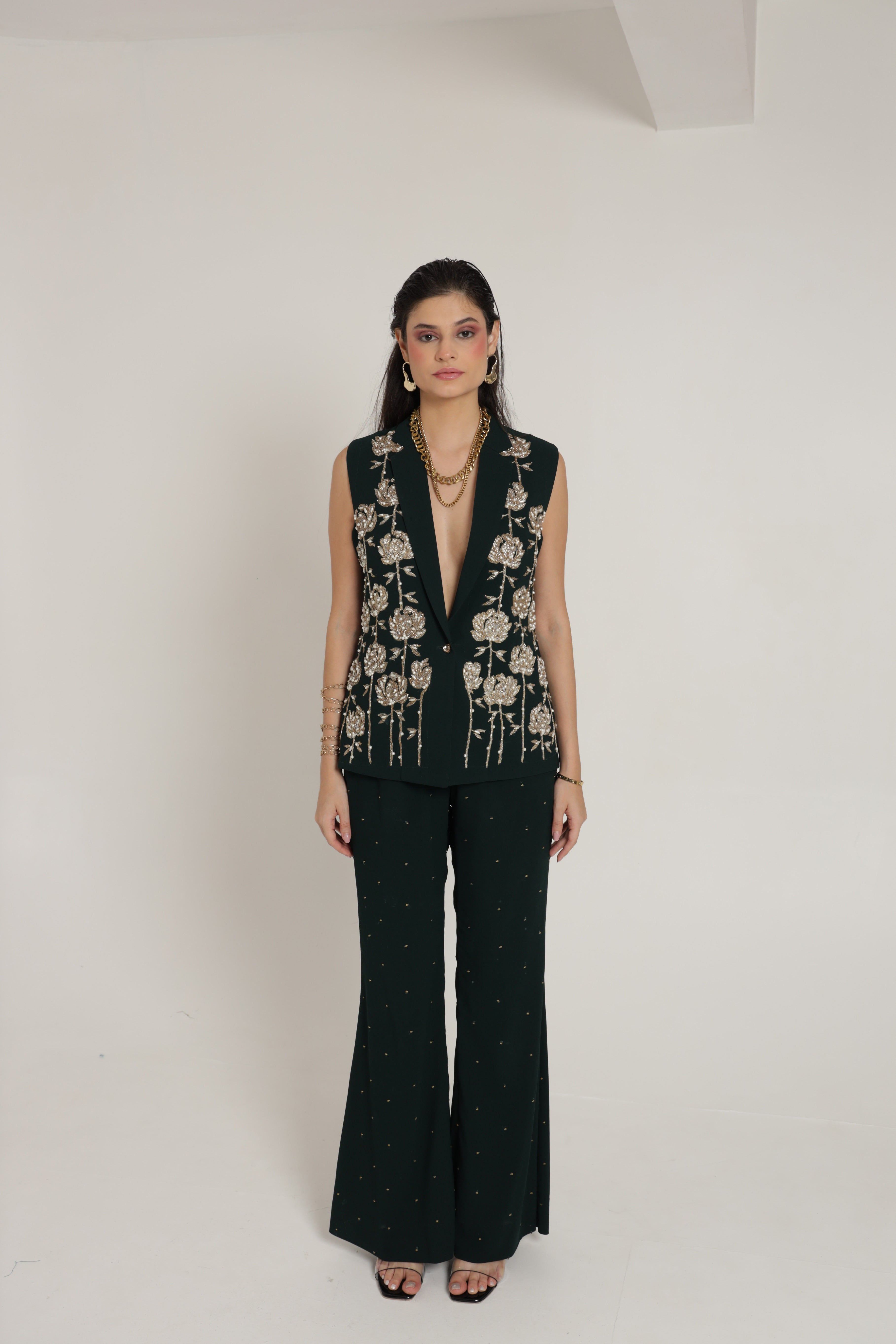 Dark green sleeveless jacket with bell bottom pant and bustier